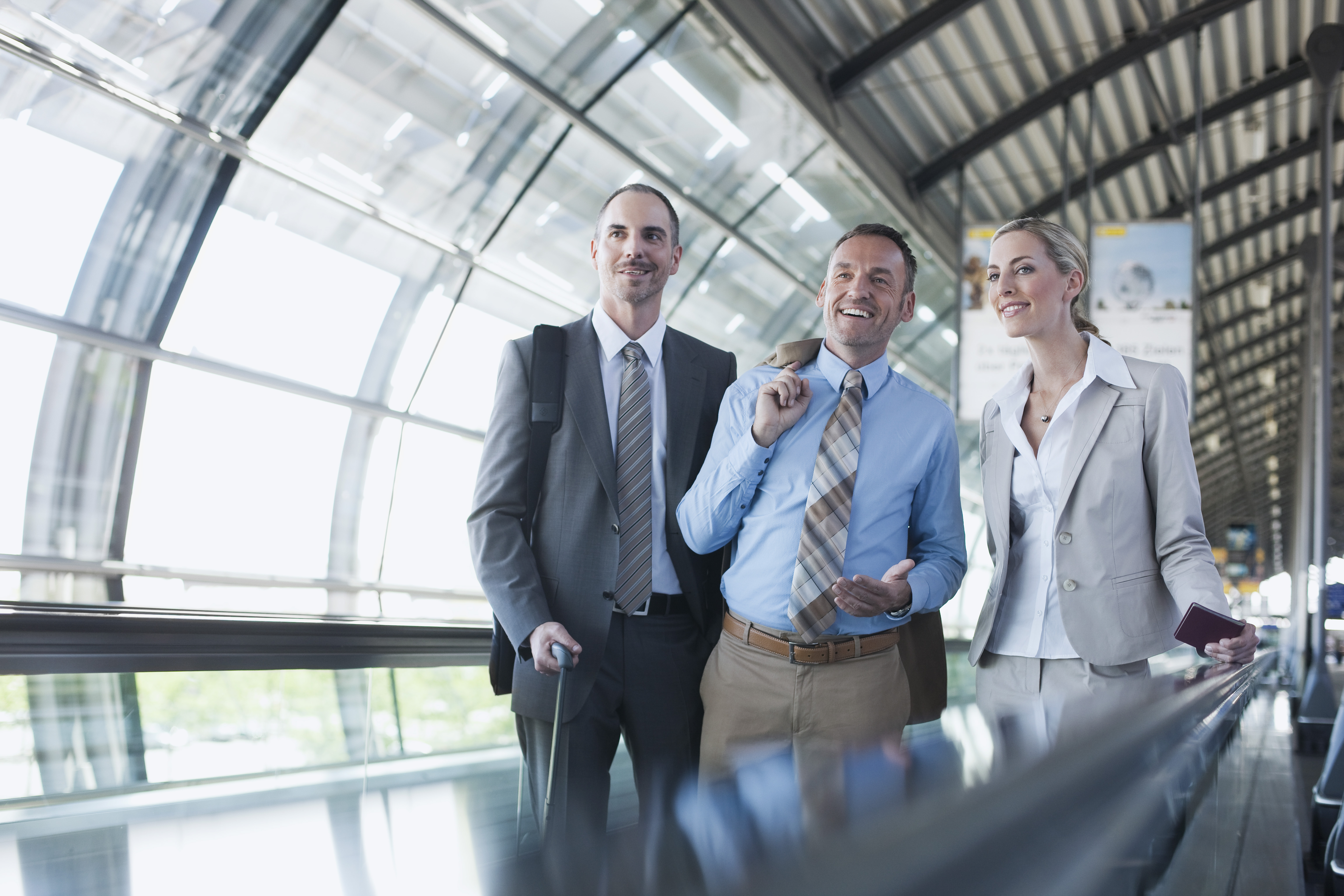 Germany, Leipzig-Halle, Airport, Business people on travelator, smiling
