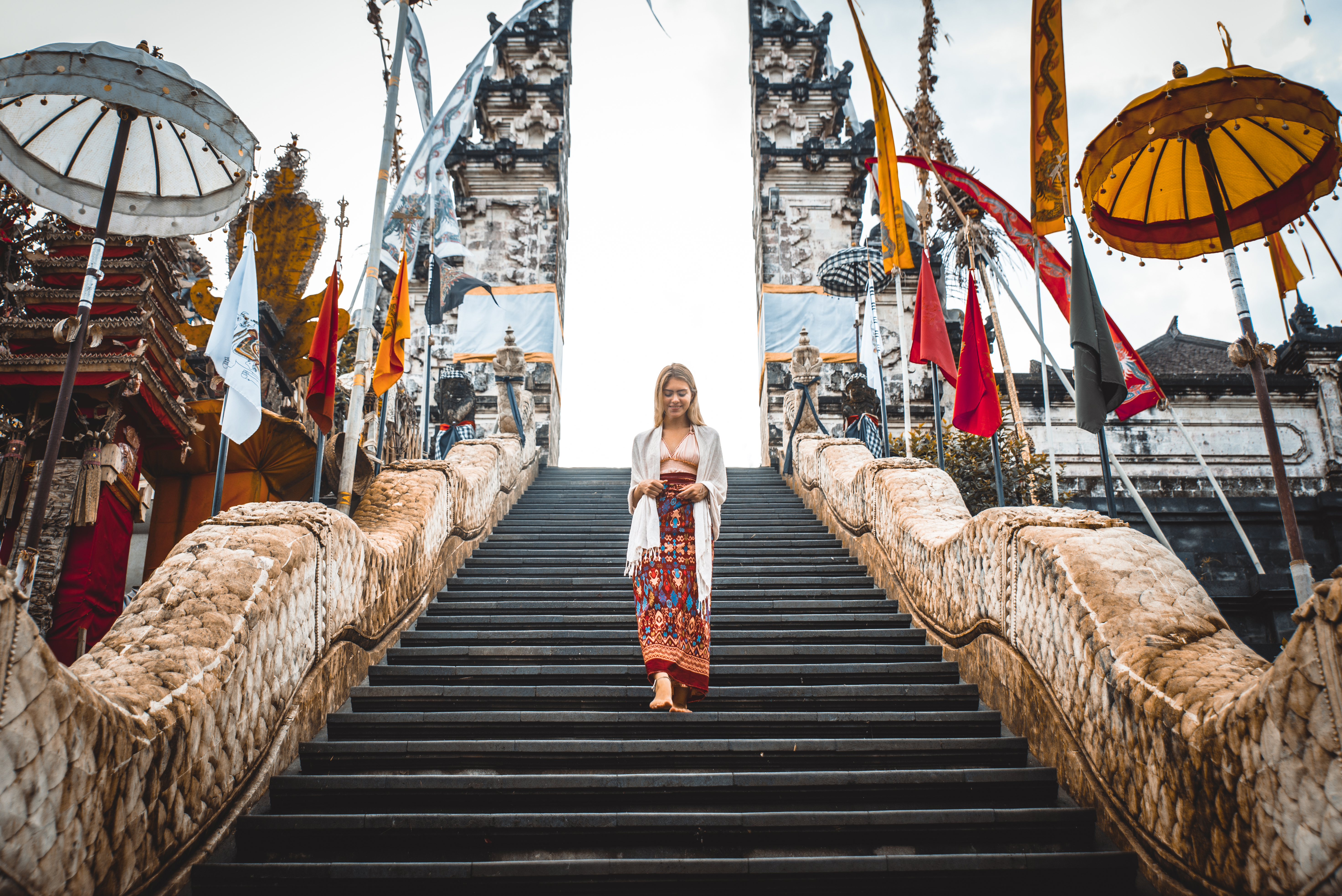 A woman at ancient gates in Pura Lempuyang ,Bali, Indonesia - Travel blogger exploring Bali landmarks